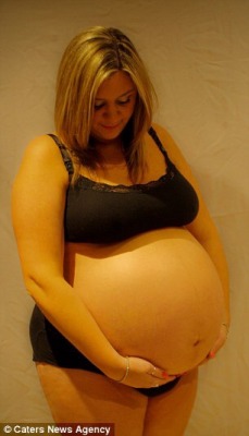 hugebellies:  Susan lovingly caressed her huge round belly. 