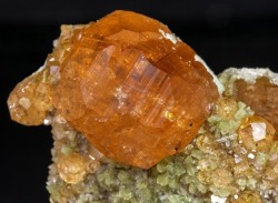 geologypage:  Grossular (variety hessonite) with Diopside | #Geology