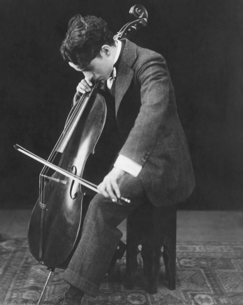 Charlie Chaplin playing the cello, ca. 1920. The comic actor
