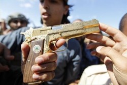 Gaddafi’s golden gun, a gold-plated 9mm Browning Hi Power. 