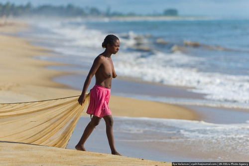 Topless Madagascan girl fishing.