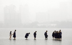 unearthedviews:Wuhan, China: Students in graduation robes stand