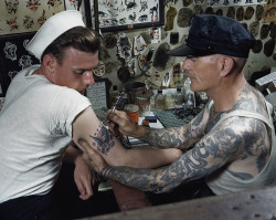 natgeofound:  A sailor gets a tattoo on his arm in Virginia.Photograph