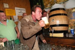 gifsboom:  PsBattle: Arnold Schwarzenegger drinking a beer at