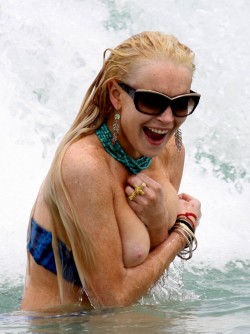 celebpaparazzi:Lindsay Lohan loses her top in the surf at Miami