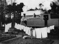  The wife of a railway worker, hangs out her washing in her garden,