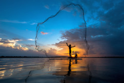 goverload:  Tropical net fishing in sunset. by Mingmuang: Tropical