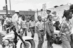 choice36c:  Police lead a group of African-American school children