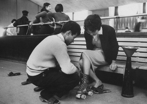 vintageeveryday:  A young man helping his date into her skating