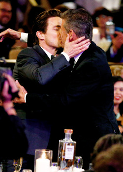  Matt Bomer kisses husband Simon Hall before accepting his award