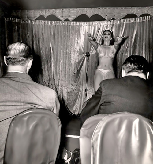 Famed photographer Weegee (Arthur Fellig) captures Sherry Britton performing on the stage of an unidentified nightclub.. Most likely, somewhere on New York City’s 52nd Street..