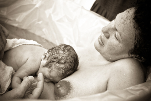 dearestpj:  My home birth, part I.Â  My midwife got there right after I got in the birthing pool, and things were very intense. Her student midwife got there soon after, right as I began to push, and she grabbed our camera to get these quick shots. My