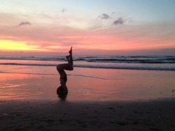fuckyeahyoga:  Sunset Garudasana in Sirsasana I on Kuta Beach,