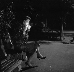 visualobscurity:  A young woman lighting a cigarette as she sits