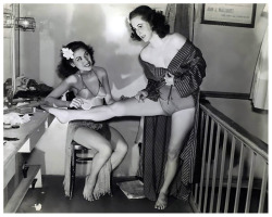 Vintage press photo (dated from June of 1940) features dancer Momi Nasaka helping fellow dancer Manu Fairchild with her makeup, as they prepare for another show .. Both showgirls were performers at ‘The HURRICANE Club’ nightclub; located in New York