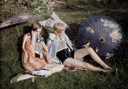  Two young girls enjoy the sun relaxing in their suits and wraps