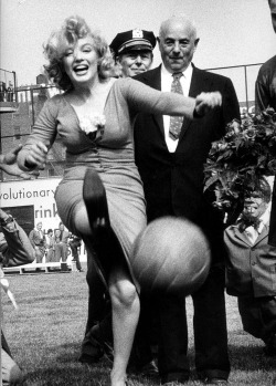 Marilyn Monroe kicks ball at Ebbet’s Field, New York, 1957.