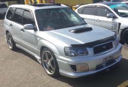 Subaru Forester SG9 with custom headlights and STI body kit at