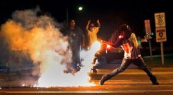 darvinasafo:  #FERGUSON protestor returns tear gas canister back