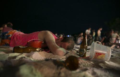 Thousands of people from around the world pack Haad Rin Beach, Koh Phangan, Thailand on August 22 2013 for the annual Full Moon Party, enjoying the cheap liquor and drugs in an all night affair. The full moon party started in late 1988 and has become