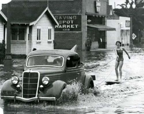 Mary Anne Hawkins surfing the flooded streets of Long Beach,