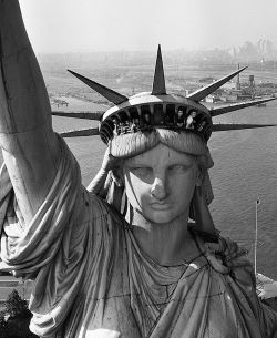 life:  Sightseers peering from the windows of the Statue of Liberty,