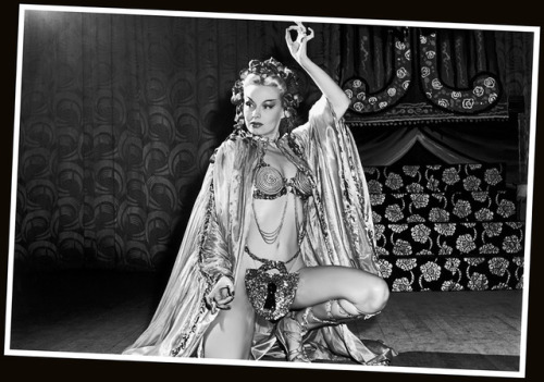 Lili St. Cyr        (aka. Marie Van Schaack)“In one of her early shows, she used a gold  Buddha placed on an altar inside a Chinese pavilion. To soft  Asian-inspired music, her movements told the story of a young bride  whose husband imprisoned