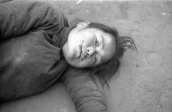 bag-of-dirt:  A starving Chinese woman, too weak to stand, lies
