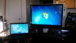 Regular laptop screen next to my new giant tv sized monitor,