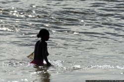 Topless Madagascan girl fishing.