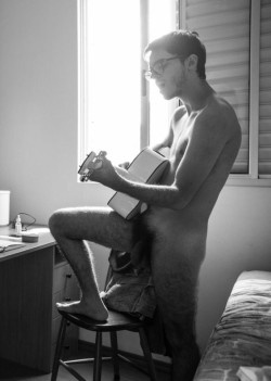 University student singing and playing the guitar in his dorm