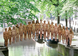 Naked volunteers stand on an invisible bridge constructed by