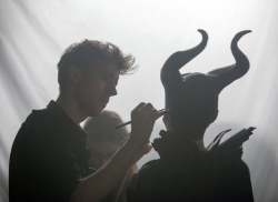  Applying makeup on the set of Maleficent. 