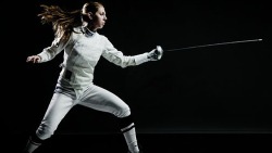 modernfencing:  [ID: an epee fencer with her mask off, doing