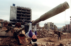 themarkedstalker:  A boy plays on a tank in the devastated Sarajevo