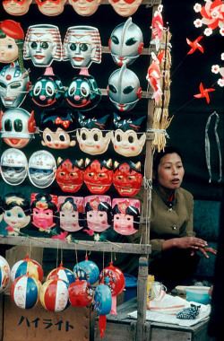 vintagegal:  Burt Glinn- A woman sells masks from a stand in