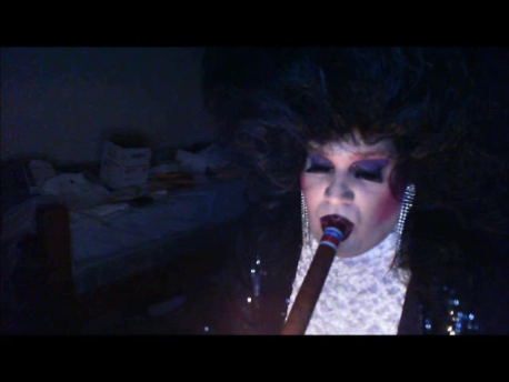 sissymarlenaexposed:  Sissy Faggot Tom Doran wearing a large black bouffant wig, black sequin jacket, white satin opera gloves, white popcorn blouse, rhinestone earrings, heavy makeup and smoking a giant cigar. 