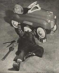 theniftyfifties:  A child performs “auto repair” on his pedal