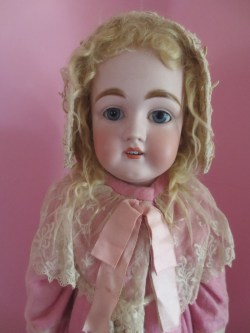 hazedolly:  Sweet antique bisque doll, all in pink. A nostalgic