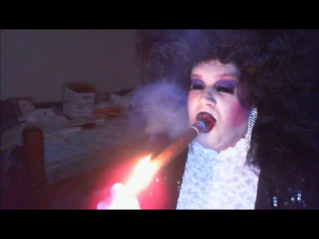 sissymarlenaexposed:  Sissy Faggot Tom Doran wearing a large black bouffant wig, black sequin jacket, white satin opera gloves, white popcorn blouse, rhinestone earrings, heavy makeup and smoking a giant cigar. 