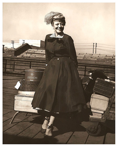 Vintage photo from 1952, shows Sally Rand waiting (with her baggage) for a train in Memphis, Tennessee.. This was a stop on the Carnival circuit, where she presented her travelling Burlesque show, entitled: “Happy Holiday”..