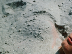 237yrs:  Simon Buried in the Sand , 1998. Nan Goldin.