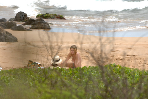 toplessbeachcelebs:Ashley BensonÂ sunbathing topless in Hawaii (July 2014)