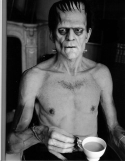 Boris Karloff relaxes on set with a cup of tea during the filming