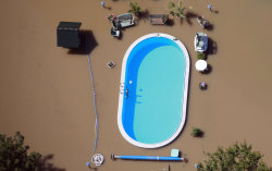  A intact pool between the dirty water of a flood in Germany