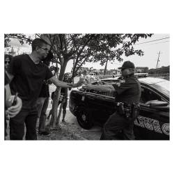 film-god:  Officer hands protesters bottled water on a hot summer