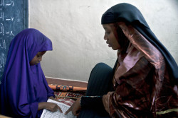 merosezah:  1. A child recites the Quran under a teacher’s