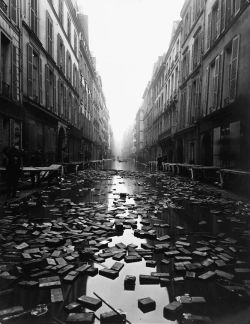  Books float on the street after a library on Rue Jacob, Paris