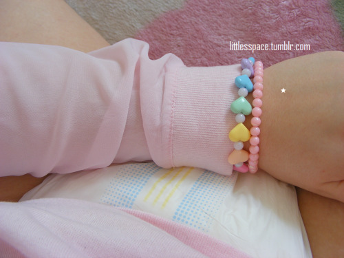 littlesspace:  I love my pink shirt. And my I LOVE DADDY paci. And my rainbow-heart necklace, that I prefer wearing as a bracelet, so I can see it, hehehe. (Diaper: Tena FeelDry Slip Plus, Size L) 