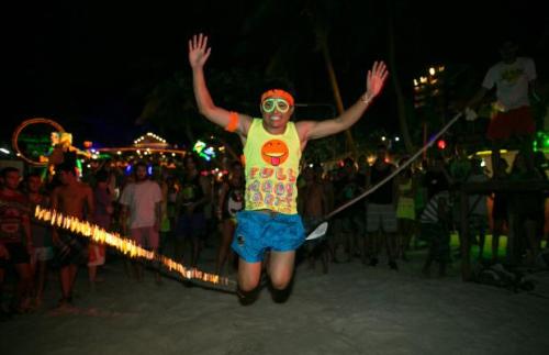 Thousands of people from around the world pack Haad Rin Beach, Koh Phangan, Thailand on August 22 2013 for the annual Full Moon Party, enjoying the cheap liquor and drugs in an all night affair. The full moon party started in late 1988 and has become